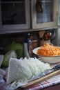 Cut cabbage and grated carrot prepared for home made cabbage sauerkrauting in old farm kitchen Royalty Free Stock Photo