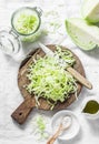 Cut cabbage on wooden chopping board on light background, top view. Vegetarian, slimming, diet food concept. Royalty Free Stock Photo