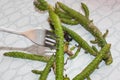Cut cactus sprouts are hooked with a food fork
