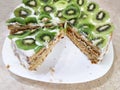 Cut cake with kiwi and ice cream on a plate close-up Royalty Free Stock Photo