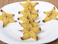 Cut carambola on a white plate - slices Royalty Free Stock Photo
