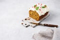 Cut of carrot cake with white icing on a ceramic board