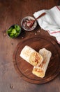 A cut Chicken doner kebab in roll of pita bread lavash. Shawarma Sandwich on a wooden background Royalty Free Stock Photo