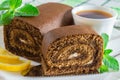 Chocolate biscuit roll and a cup of tea with lemon slices