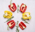 Cut colorful fresh peppers with herbs on wooden rustic background top view close up Royalty Free Stock Photo