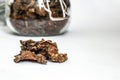 Cut dry root of Rhodiola rosea in a glass jar on natural white background