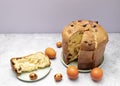 Cut Easter Panettone Italian Cake On Table With Colored Easter Hen, Quail Eggs. Fruitcake