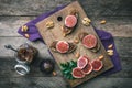 Cut figs, nuts and bread with jam on wooden choppingboard Royalty Free Stock Photo