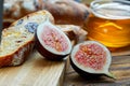 Cut figs on a wooden Board watered with honey. Rustic style