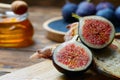 Cut figs on a wooden Board watered with honey. Rustic style