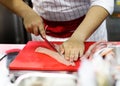 Cut fish fillet in a fish shop, chef cutting fish in the kitchen Royalty Free Stock Photo