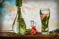 Cut flowers and tropical plants in a glass of water on a barn wood table Royalty Free Stock Photo