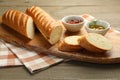Cut fresh baguette served on wooden table, closeup Royalty Free Stock Photo