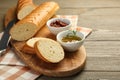 Cut fresh baguette served on wooden table, closeup Royalty Free Stock Photo