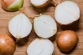 Cut fresh bulbs of onion on a bamboo chopboard Royalty Free Stock Photo