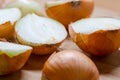 Cut fresh bulbs of onion on a bamboo chopboard Royalty Free Stock Photo
