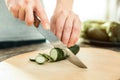 Cut fresh cucumber being under the knife.