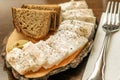 Cut fresh fat with black bread on the wooden board serving in restaurant