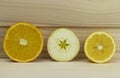 Cut fresh juicy natural sour apple orange lemon lime half on wooden background Royalty Free Stock Photo