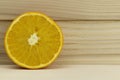 Cut fresh juicy natural sour orange on wooden background