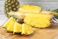 Cut fresh juicy pineapple on wooden board Royalty Free Stock Photo