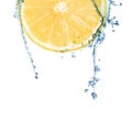 Cut fresh lemon and splashing water on white background Royalty Free Stock Photo