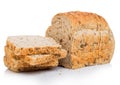 Cut of fresh loaf of seeded brown bread on white background. Traditional bakery heritage Royalty Free Stock Photo