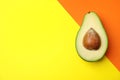 Cut fresh ripe avocado on color background, top view Royalty Free Stock Photo