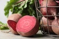 Cut fresh ripe beets on grey table, closeup