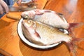 Cut fresh river fish with a knife