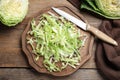 Cut fresh savoy cabbage on wooden table, flat lay Royalty Free Stock Photo