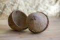 Full coconut with nutshells on wooden bamboo table Royalty Free Stock Photo