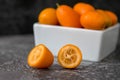 Cut fruit kumquat on a black background