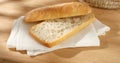 cut in half ciabatta bread on a napkin on a wooden background. Royalty Free Stock Photo