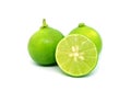 Cut in half fresh lime with whole fruits isolated on white backdrop Royalty Free Stock Photo