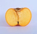 The cut in half persimmon on white background