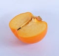 The cut in half persimmon on white background