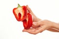 cut in half red pepper in hands on a light background vegetables