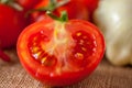 Cut in half red tomato on vegetable background Royalty Free Stock Photo