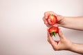 Cut in half strawberry in hand on a white background. Healthy eating Royalty Free Stock Photo