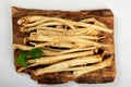 Cut Horseradish roots Armoracia rusticana taproot on rustic wooden board Royalty Free Stock Photo