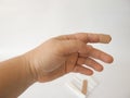 Cut index finger. Adhesive plaster or bandage. White background Royalty Free Stock Photo