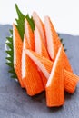 Cut Kani Crab Stick Sashimi Served with Sliced Radish on Stone Plate