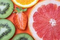 Cut kiwi, grapefruit, strawberry and orange. Fruits summer background. Citruses bright texture, tropical colorful pattern Royalty Free Stock Photo