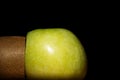 Cut kiwi and green apple on a black background