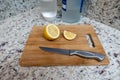 A cut lemon on a wooden cutting board Royalty Free Stock Photo