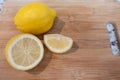 A cut lemon on a wooden cutting board Royalty Free Stock Photo