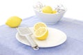 Lemons and zester on a white plate