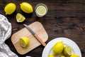 Cut lemons for lemonade. Lemons, glass, knife, cutting board on wooden background top view copyspace Royalty Free Stock Photo