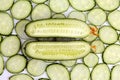 Cut lengthwise the cucumber on the background of sliced cucumber Royalty Free Stock Photo